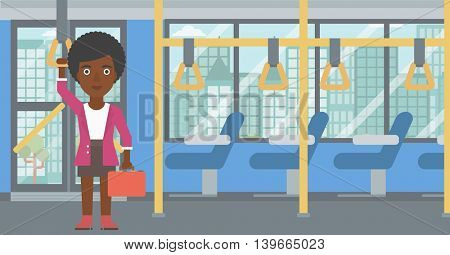 An african-american woman traveling by public transport. Young woman standing inside public transport. Woman traveling by passenger bus or subway. Vector flat design illustration. Horizontal layout.