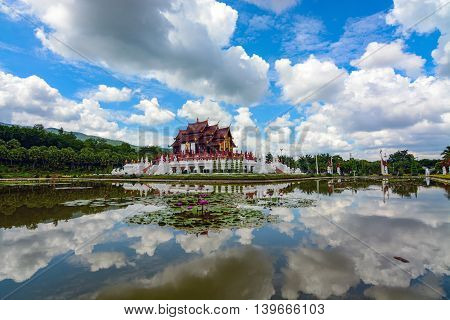 Chiang Mai, Thailand - July 22, 2016: Summer sky and Ho Kham Luang Pavilion reflecting in the pond at Royal Park Rajapruek.