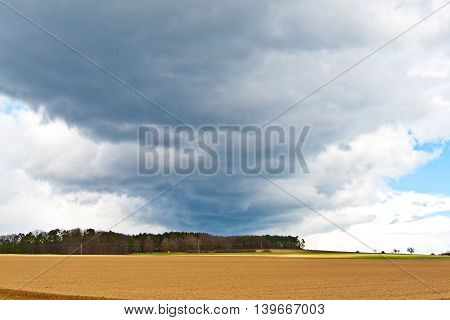 Dark Clouds And Blue Sky Over Fields