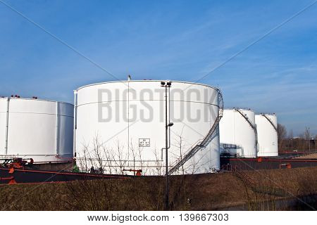 White Tanks In Tank Farm With Blue Sky