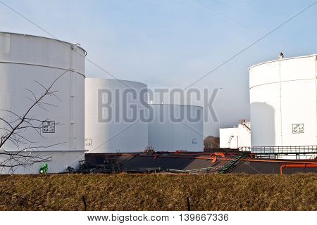 White Tanks In Tank Farm With Blue Sky