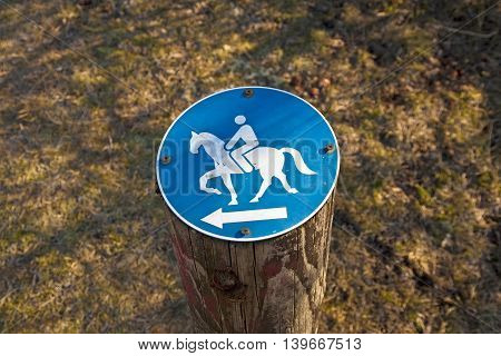 sign riding allowed nailed on a stem in the forest