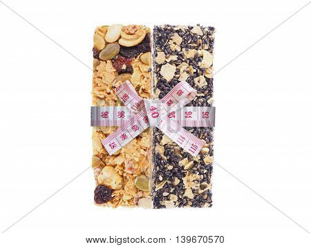 Healthy granola and measure tape bow tied isolated on white background. Diet and healthy concept.