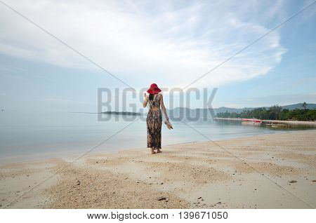 Beautiful woman walk on the beach in Koh Samui, Surat Thani Province, Thailand