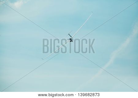 The glider gliding in the blue sky glider flight