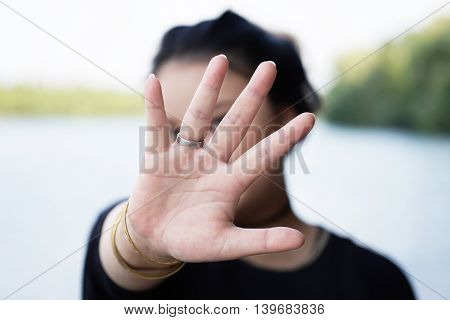 woman hiding face behind hand. defense reaction.