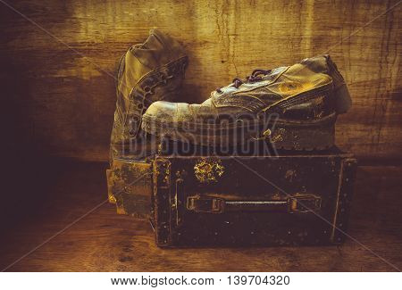 Still life with old jungle boot on iron bullet box