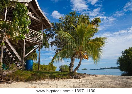 Photo Untouched Tropical Beach in Bali Island. Summer Season. Bungalow in Indonesia village. Horizontal Picture