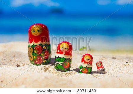 Photo Rows Puzzle Russian Dolls Matrioshka Souvenir Untouched Tropical Beach in Bali Island. Horizontal Picture. Blurred Background. Closeup