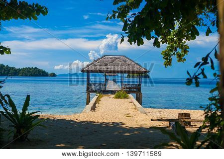 Photo Bungalow in Indonesia village Tropical Beach in Bali Island. Summer Season Caribbean ocean. Horizontal Picture