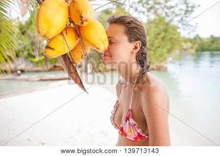 Young girl relaxing on beach. Smiling woman spending chill time Outdoor Bali Tropical Island. Summer Season Caribbean Ocean. Horizontal picture. Blurred background