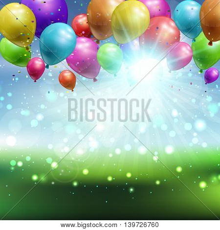 Balloons and confetti on a defocussed landscape background