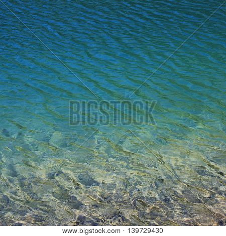 Clear and clean water of lake Klontal Swiss Alps. Nature background.