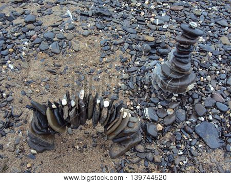 Stone pile upon beach photographed at Crackington Haven in Cornwall
