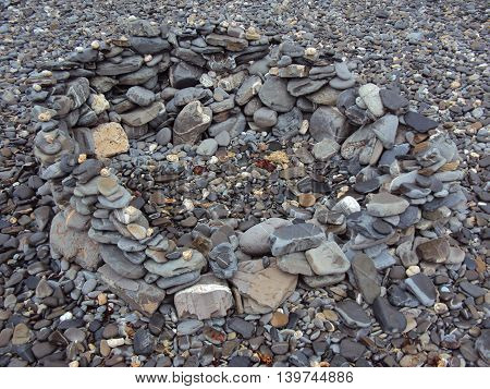 Stone pile upon beach photographed at Crackington Haven in Cornwall