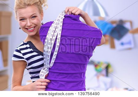 Modern young fashion designer working at studio.isolated