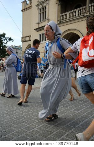 CRACOW POLAND - JULY 24 2016: Pilgrims of World Youth Day sing and dance on the Main Square in Cracow. Poland