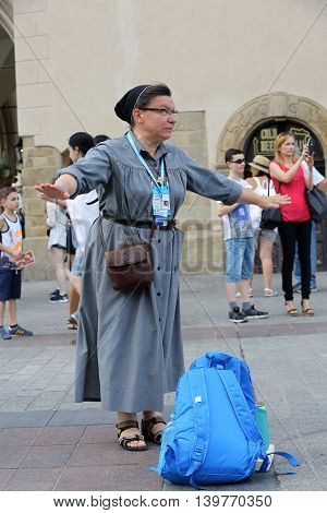 CRACOW POLAND - JULY 24 2016: Pilgrims of World Youth Day sing and dance on the Main Square in Cracow. Poland
