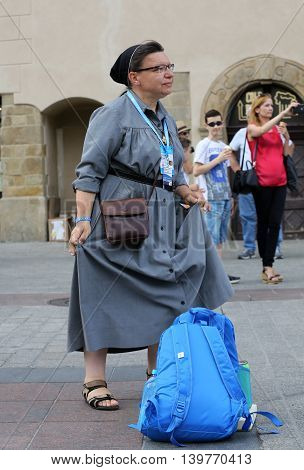 CRACOW POLAND - JULY 24 2016: Pilgrims of World Youth Day sing and dance on the Main Square in Cracow. Poland