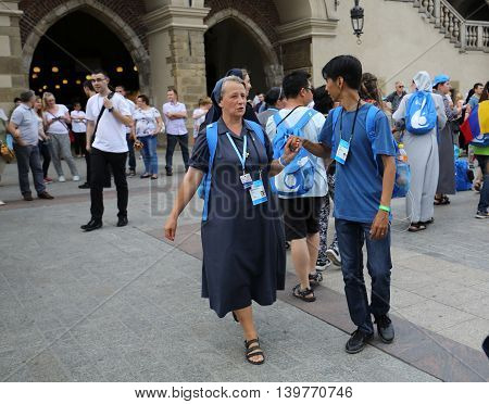 CRACOW POLAND - JULY 24 2016: Pilgrims of World Youth Day sing and dance on the Main Square in Cracow. Poland