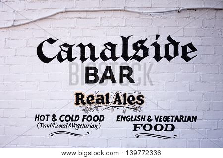BIRMINGHAM, UNITED KINGDOM - JUNE 6, 2016 - Canalside bar sign painted on a brick wall in Gas Street Basin Birmingham England UK Western Europe, June 6, 2016.