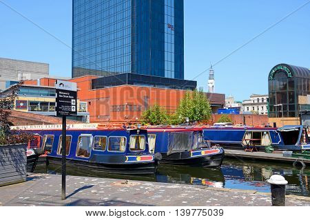 BIRMINGHAM, UNITED KINGDOM - JUNE 6, 2016 - Rear view of the Hyatt Hotel with narrowboats in the foreground at Gas Street Basin Birmingham England UK Western Europe, June 6, 2016.