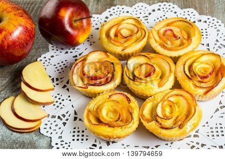 Puff apple shaped roses muffins. Sweet apple dessert pie. Homemade apple rose pastry.