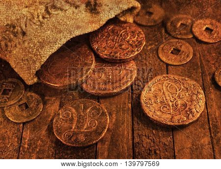 Ancient coins on wooden background with texture effect