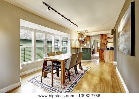 Cozy Creamy Tones Dining Room With Wooden Table Set.