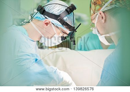 male cardiac surgeon at child cardiosurgery operating room