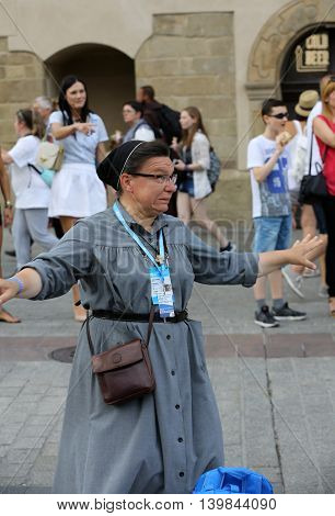 CRACOW POLAND - JULY 24 2016: Pilgrims of World Youth Day sing and dance on the Main Square in Cracow. Poland
