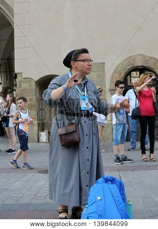 CRACOW POLAND - JULY 24 2016: Pilgrims of World Youth Day sing and dance on the Main Square in Cracow. Poland