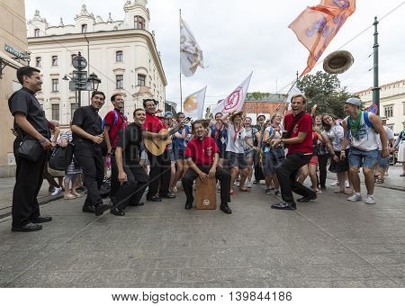 CRACOW POLAND - JULY 24 2016: Pilgrims of World Youth Day sing and dance on the Main Square in Cracow. Poland