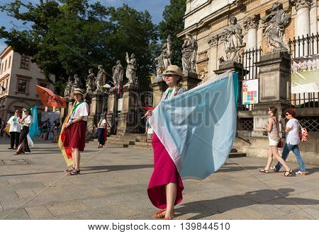 CRACOW POLAND - JULY 24 2016: Pilgrims of World Youth Day sing and dance on the St. Maria Magdalena Square in Cracow. Poland
