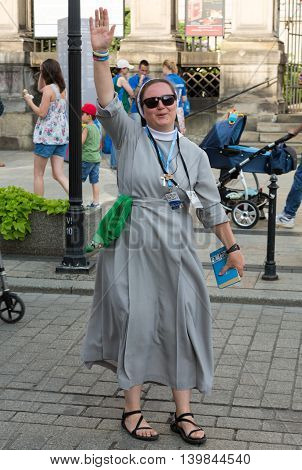 CRACOW POLAND - JULY 24 2016: Pilgrims of World Youth Day sing and dance on the St. Maria Magdalena Square in Cracow. Poland
