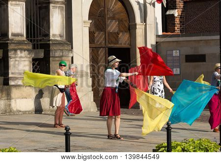 CRACOW POLAND - JULY 24 2016: Pilgrims of World Youth Day sing and dance on the St. Maria Magdalena Square in Cracow. Poland