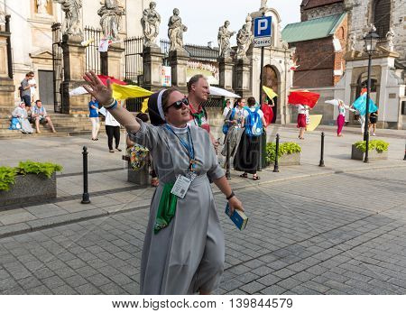 CRACOW POLAND - JULY 24 2016: Pilgrims of World Youth Day sing and dance on the St. Maria Magdalena Square in Cracow. Poland
