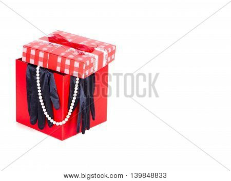 red gift box black satin gloves white pearl necklace. gift. gift surprise retro white background