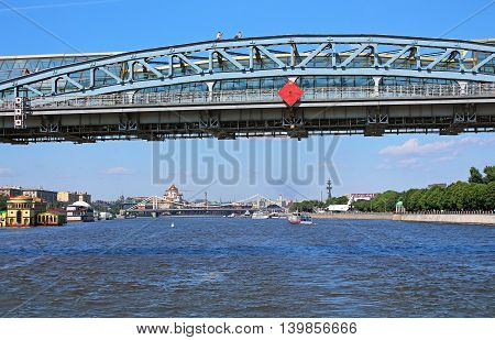 MOSCOW, RUSSIA - JUNE 05 ,2013: Moscow river and Pedestrian Andreevsky bridge in Moscow, Russia. The name ofbridge refers to a historical bridge demolished in 1998 and three existing bridges across Moskva River, located between Luzhniki and Gorky Par
