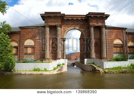Old arch of the New Holland, day in June. View from the Moika river embankment, Saint Petersburg