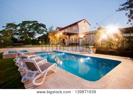 House And Swimming Pool Decoration At Evening With Flashing Ligh