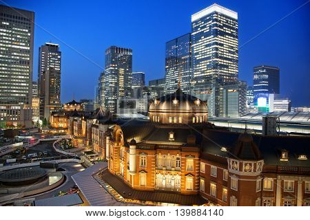 The exterior of the famous Tokyo Train Station at night, which has stood in the Marunouchi district for over 100 years. All identifiable logos removed. 