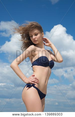 Young beautiful and sexy woman relaxing on a summer beach one