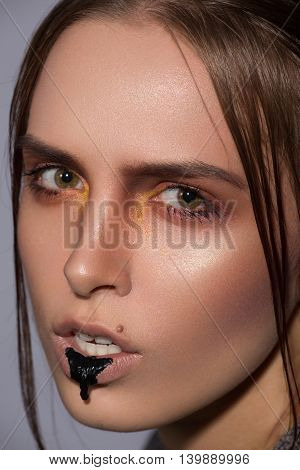 beauty creative makeup with black blob lips