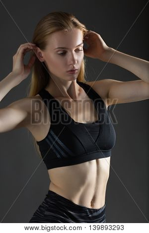 Beautiful sexy blonde woman perfect athletic slim figure engaged in yoga exercise or fitness lead healthy lifestyle eats right dressed in comfortable casual clothes sport pilates diet