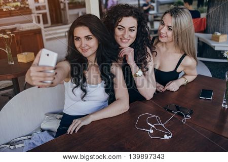 Girls walking around town, sit in cafes and pictures on phones
