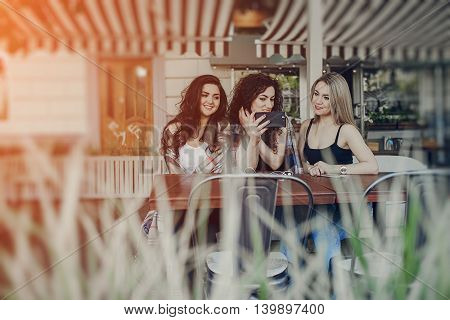 Girls walking around town, sit in cafes and pictures on phones