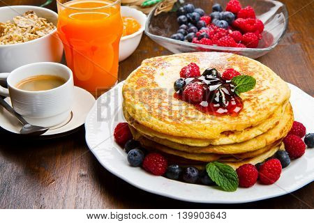 some Pancakes with berries and maple syrup