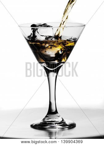 Alcoholic drink with splash in the ices o white background