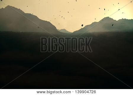 Abstract backlit paper mountains on sunset background. 3D Rendering